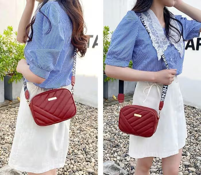 Person wearing a blue checkered shirt and white skirt with a red quilted bag outdoors.