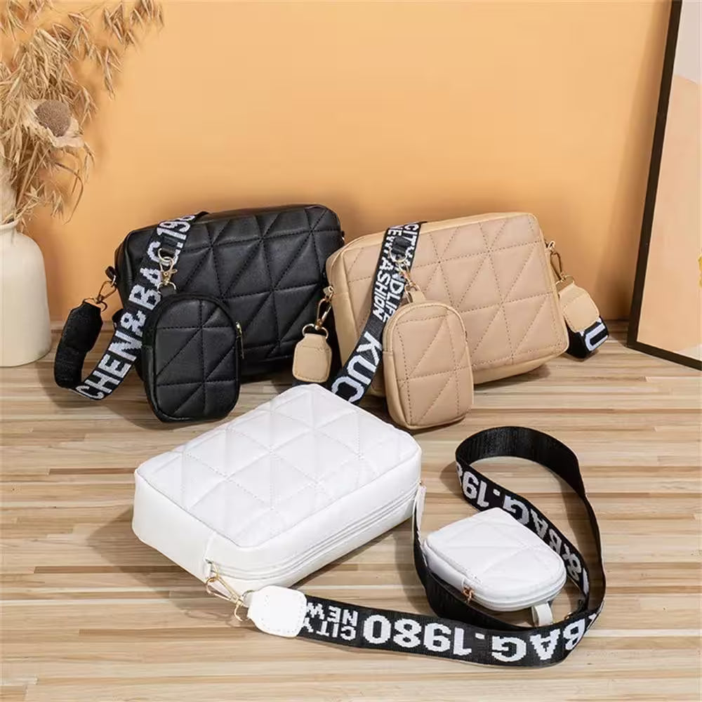 Three handbags in black, beige, and white with visible branding on straps against a wooden surface.