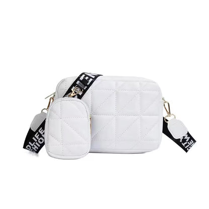 White quilted handbag with black and gold accents on a white background