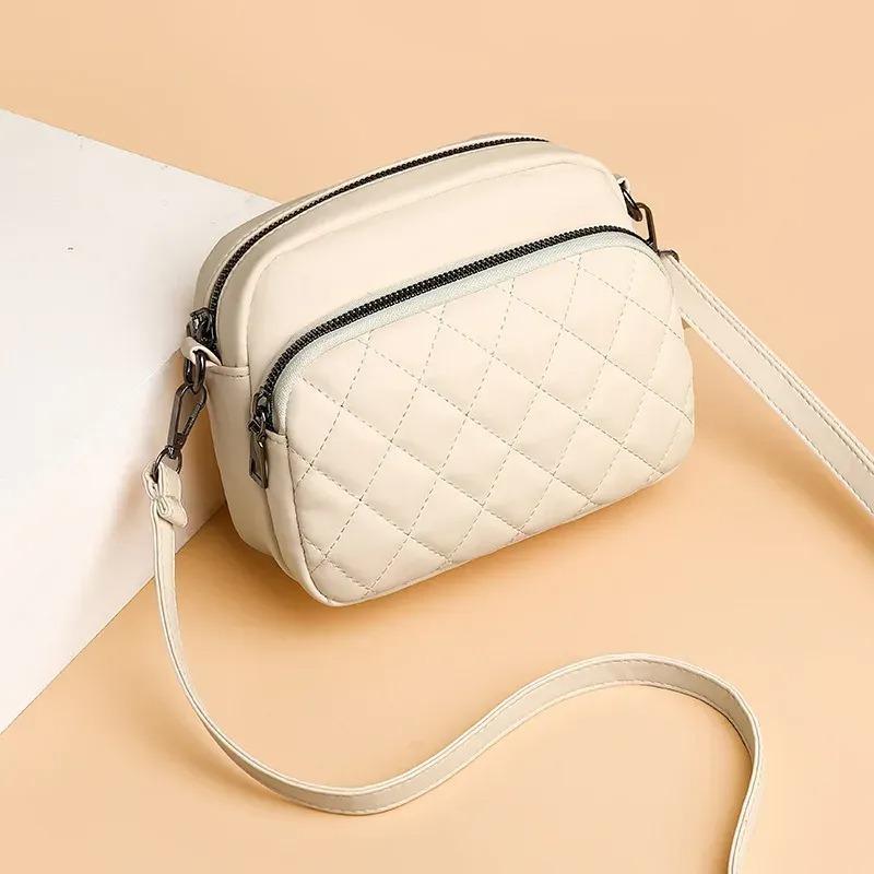 Quilted beige handbag with a strap on a beige background
