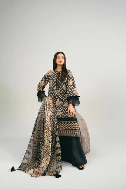 Woman wearing a patterned dress with a long scarf on a white background