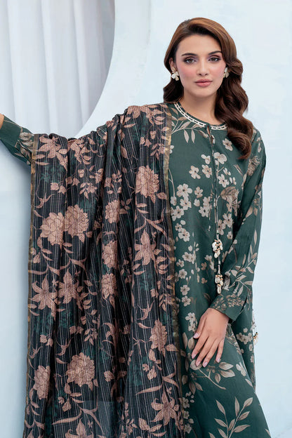 Woman wearing a green floral dress with a matching jacket against a white curtain background