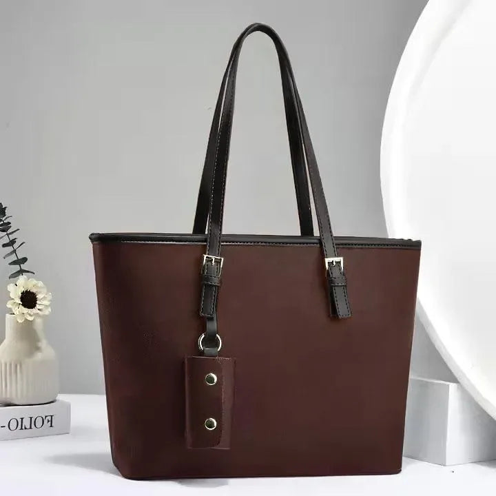 Brown handbag with a strap on a light gray background