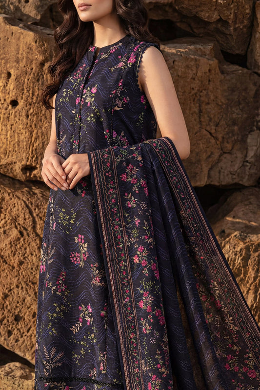 Woman wearing a dark floral dress against a stone wall
