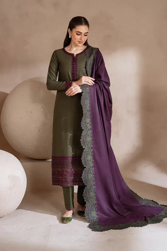 Woman wearing a green and purple traditional outfit with a matching dupatta against a neutral background