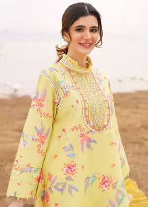 Woman wearing a yellow floral embroidered dress in an outdoor setting