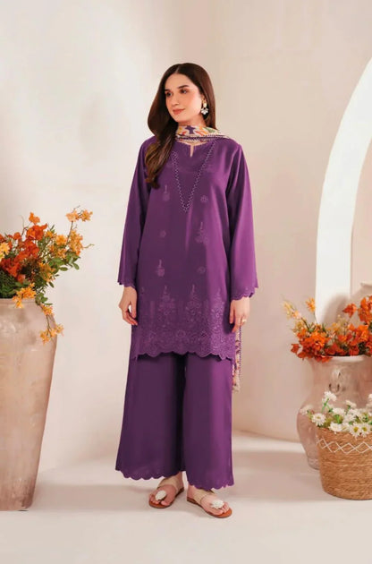 Woman wearing a purple outfit with floral decorations in a decorated setting