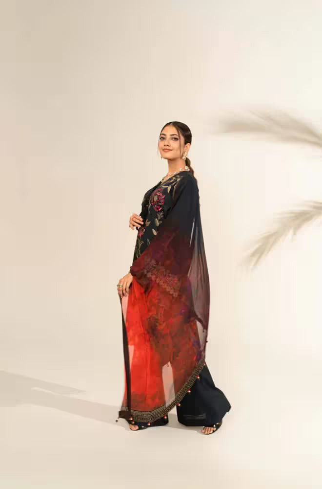 Woman wearing a traditional outfit with a red and black saree on a white background
