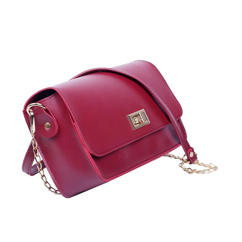 Red handbag with a gold chain on a white background