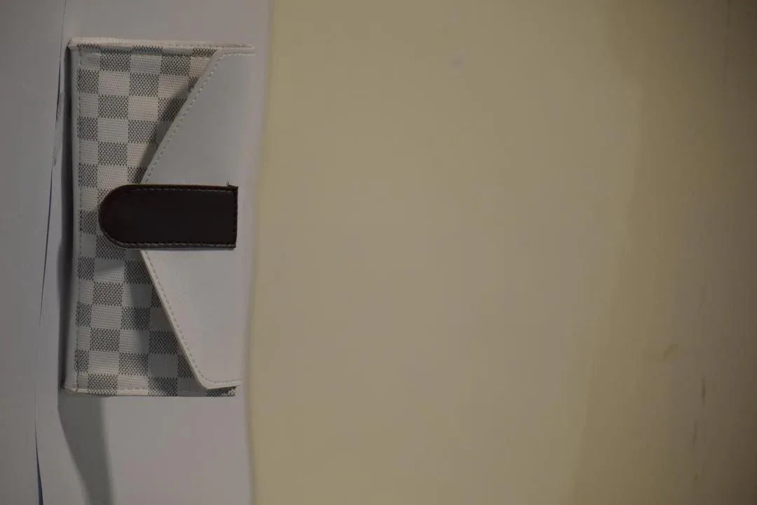 Small checkered mat with a black object on a light-colored floor