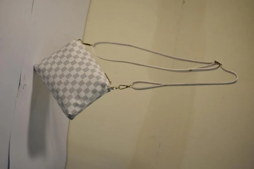 Checkered handbag with a strap on a plain background
