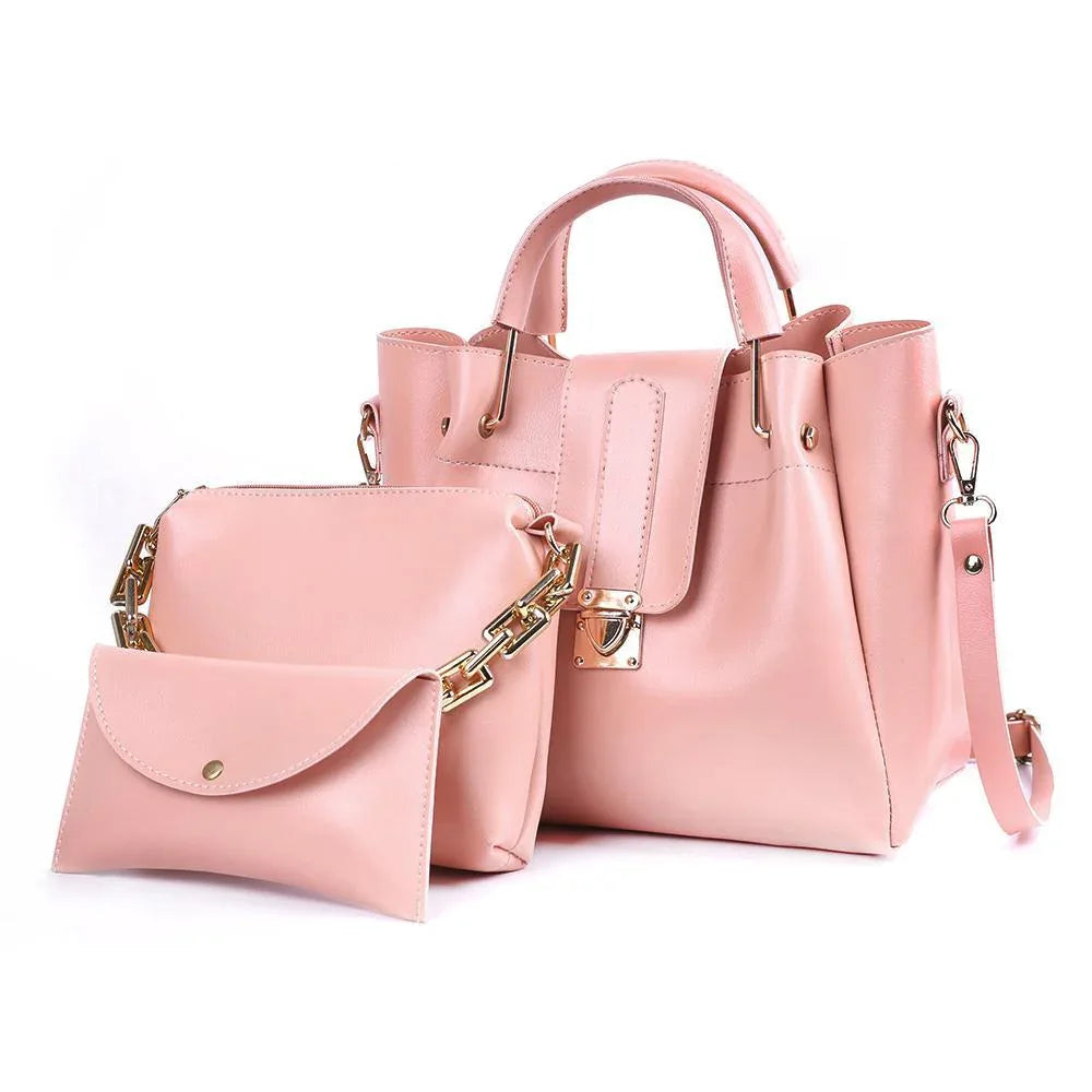 Pink handbag and matching pouch with gold accents on a white background