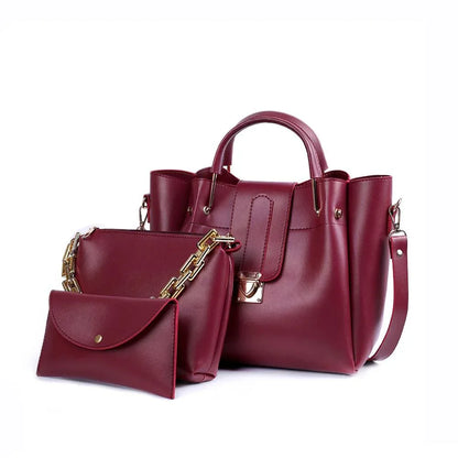 Maroon handbag with gold accents on a white background