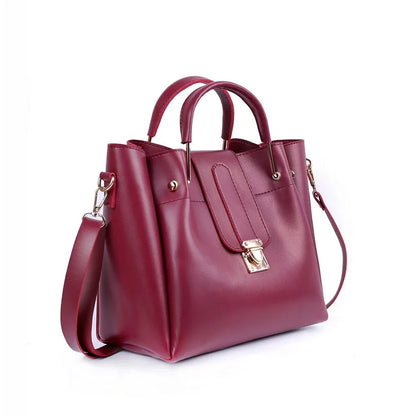 Maroon handbag with gold accents on a white background