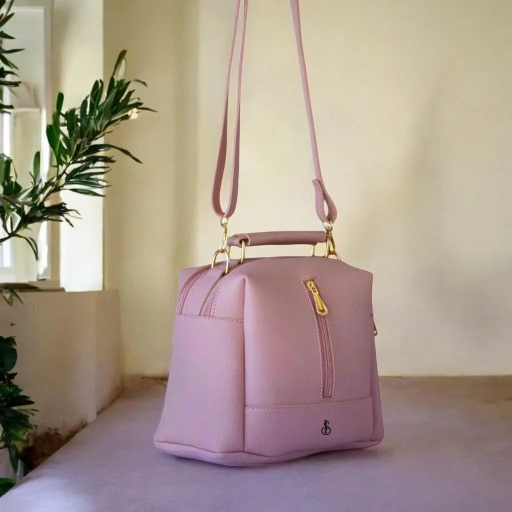 Pink handbag on a surface with a neutral background