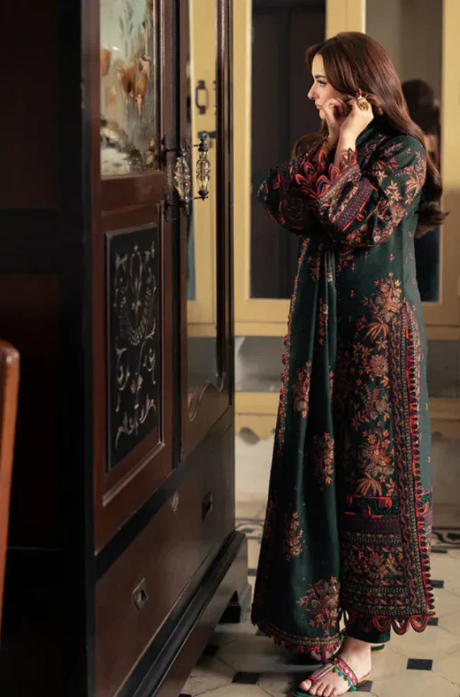 Woman in a floral dress standing in a room with wooden furniture.