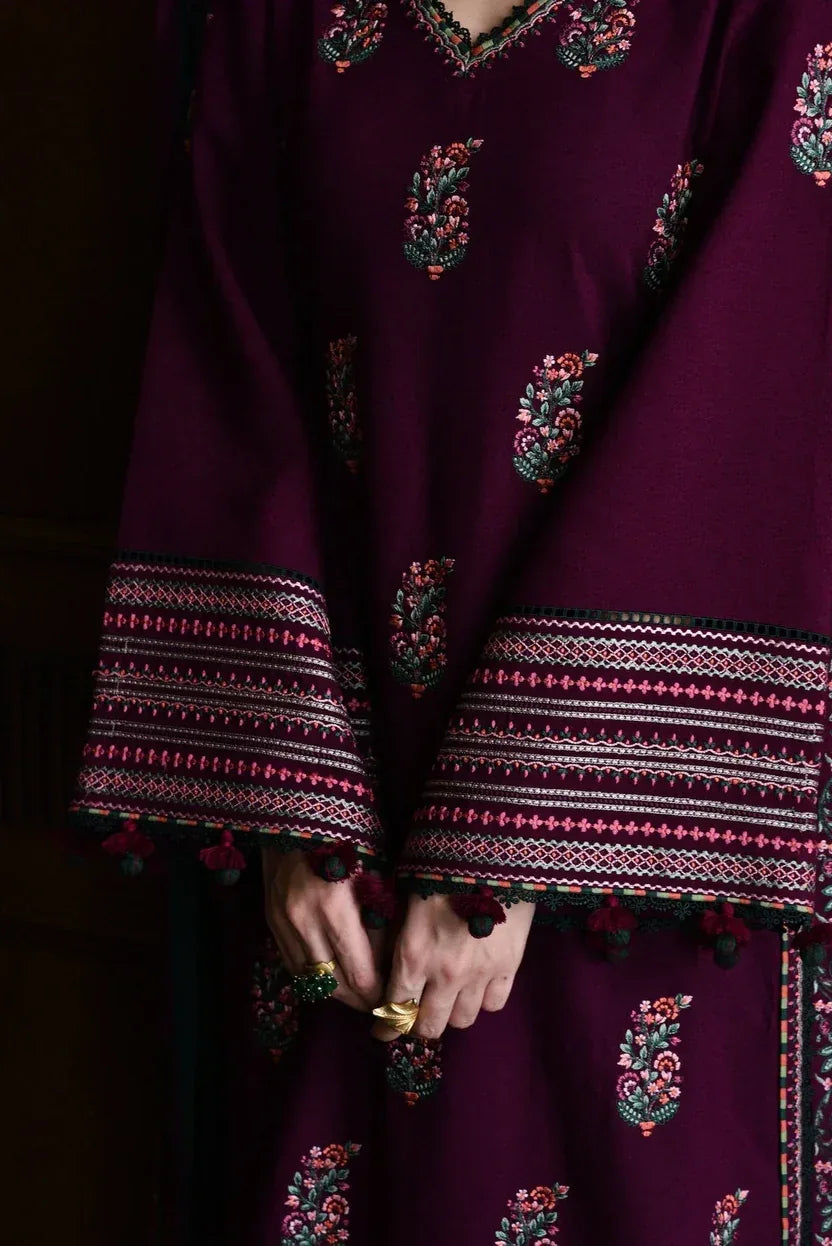 Purple traditional outfit with intricate patterns on a dark background