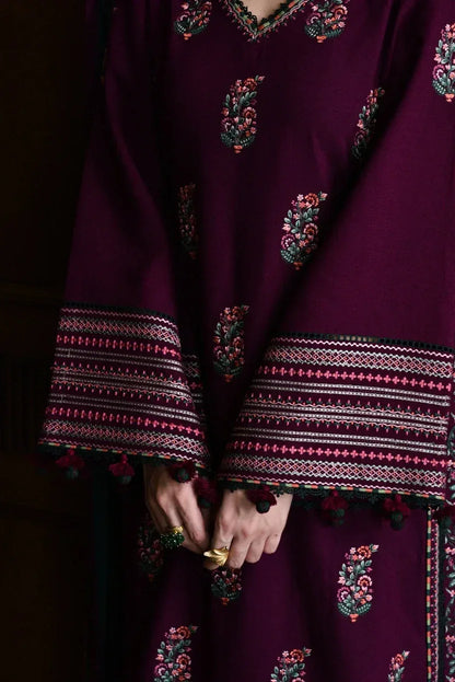Purple traditional outfit with intricate patterns on a dark background