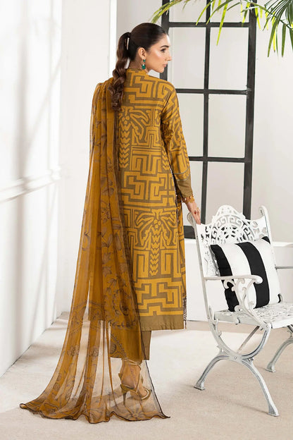 Woman wearing a mustard yellow traditional outfit with a sheer dupatta in a minimal indoor setting.