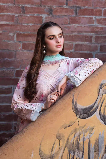 Woman in a traditional outfit leaning against a decorative wall with a brick background