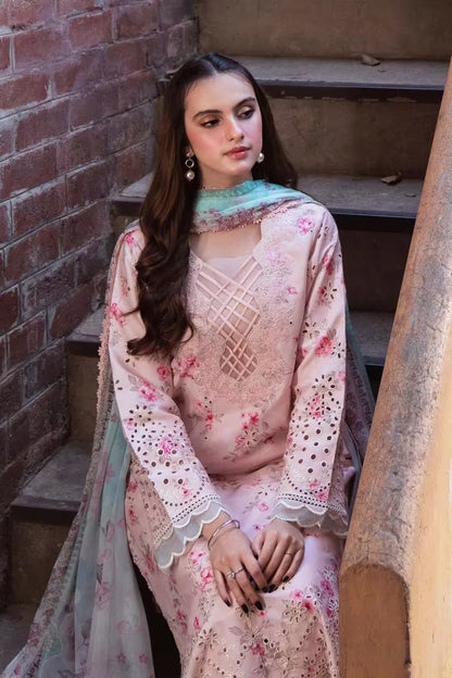 Woman in a floral dress sitting on steps against a brick wall
