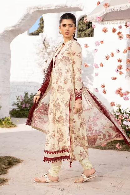 Woman in a floral outfit standing in front of a white archway with flowers.