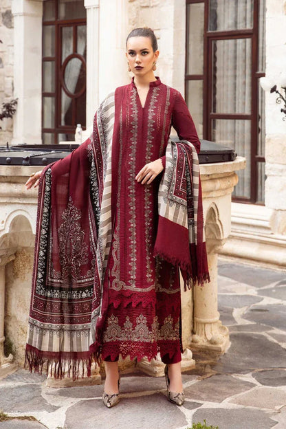Woman in a red traditional outfit with a matching shawl standing in front of classical architecture.