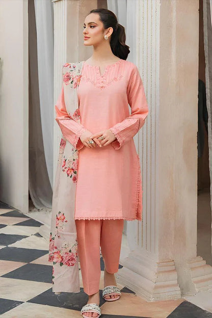 Woman wearing a peach-colored traditional outfit with floral details in an elegant indoor setting.