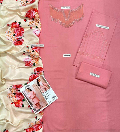 Pink fabric with floral design and 'Dhanak' branding, accompanied by a magazine and fabric swatch.