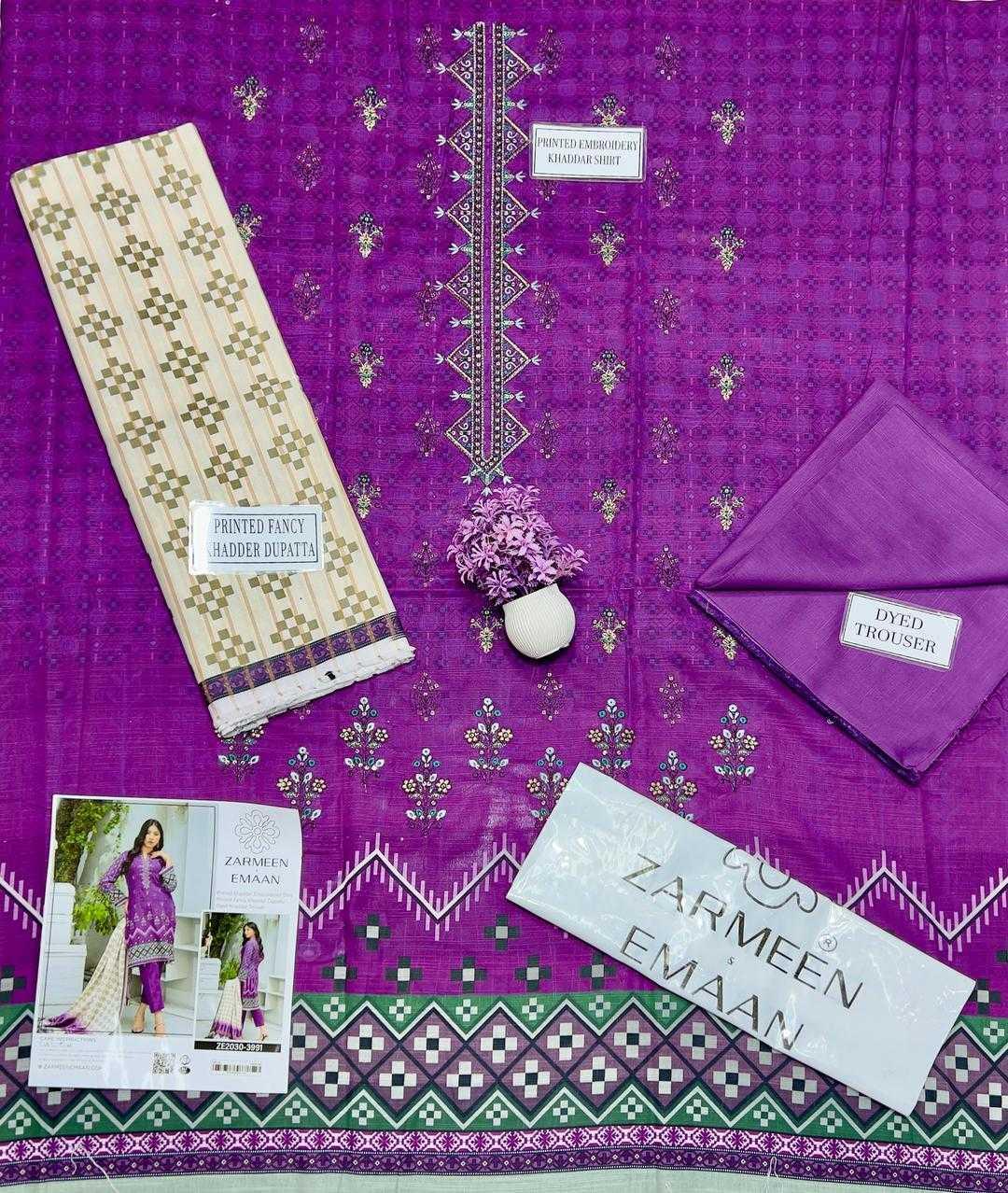 Purple fabric with embroidered patterns and clothing items on a matching fabric background.