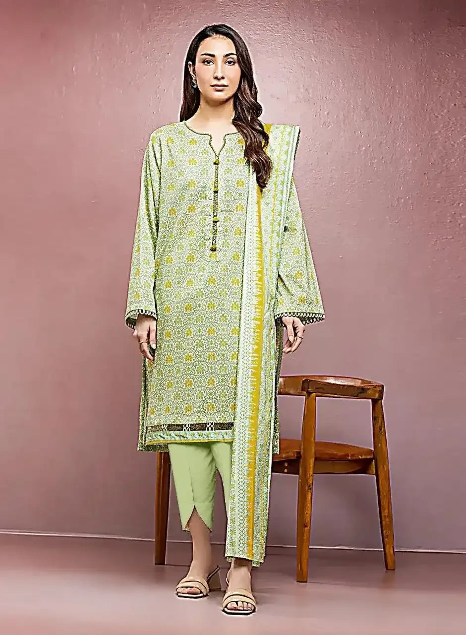 Woman wearing a green and yellow traditional outfit against a pink background