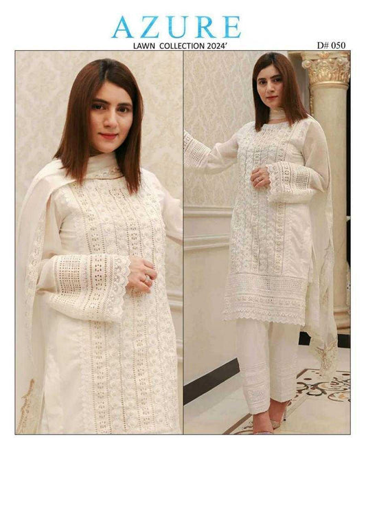 Woman wearing a white outfit with lace details in a room setting, Azure Lawn Collection 2024.