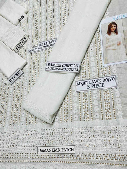 Textiles with labels indicating fabric types and patterns on a textured surface.