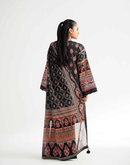 Woman wearing a black patterned dress with a white background