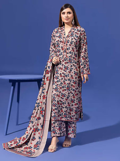 Woman wearing a floral outfit with a matching dupatta on a blue background