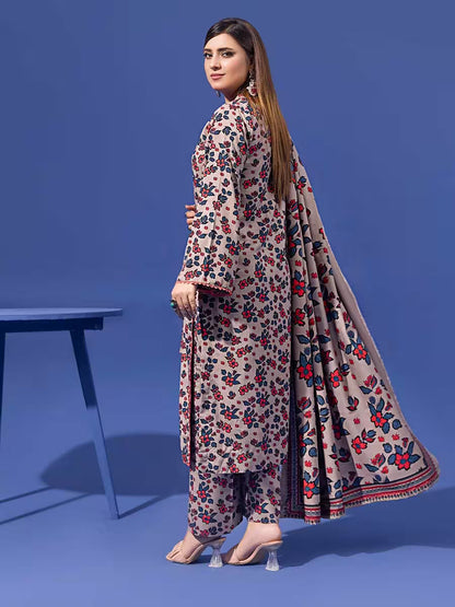 Woman wearing a floral dress with a long scarf against a blue background