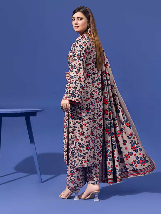 Woman wearing a floral dress with a long scarf against a blue background