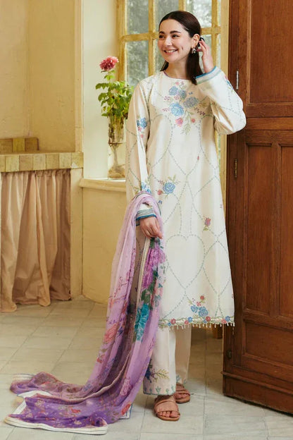 Woman in a floral outfit with a matching shawl standing indoors.
