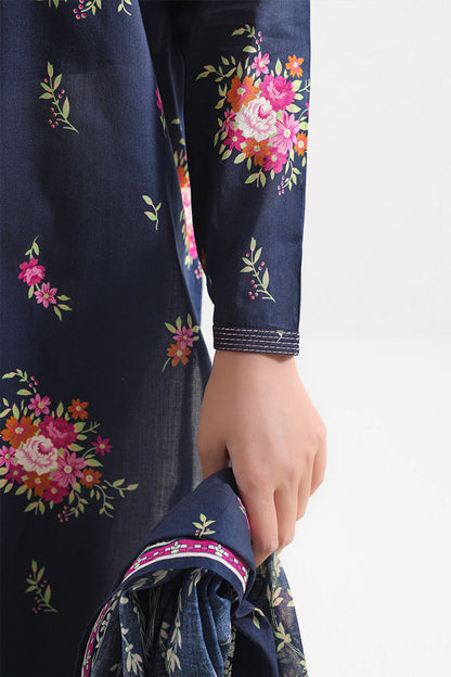Navy blue fabric with floral embroidery held by a hand on a white background