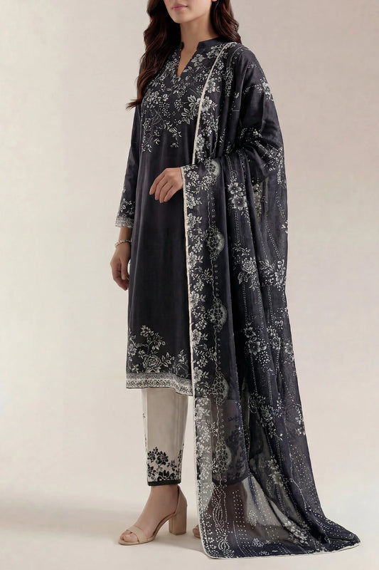 Woman wearing a dark gray floral printed outfit with a matching dupatta on a light background