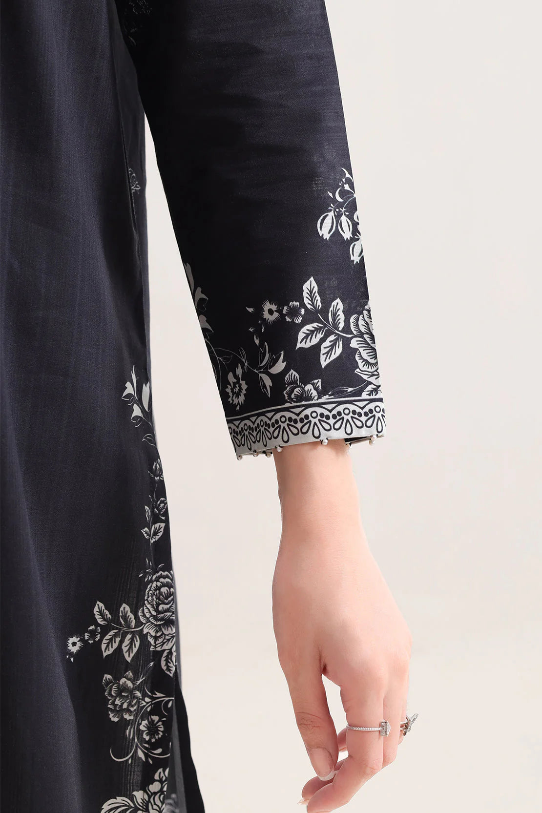 Navy blue fabric with white floral embroidery on a plain background
