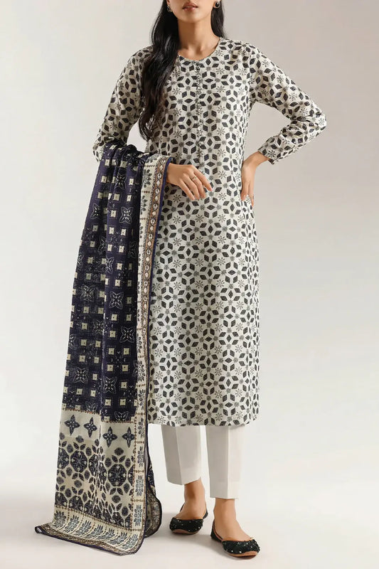 Woman wearing a patterned kurta with a matching dupatta on a plain background