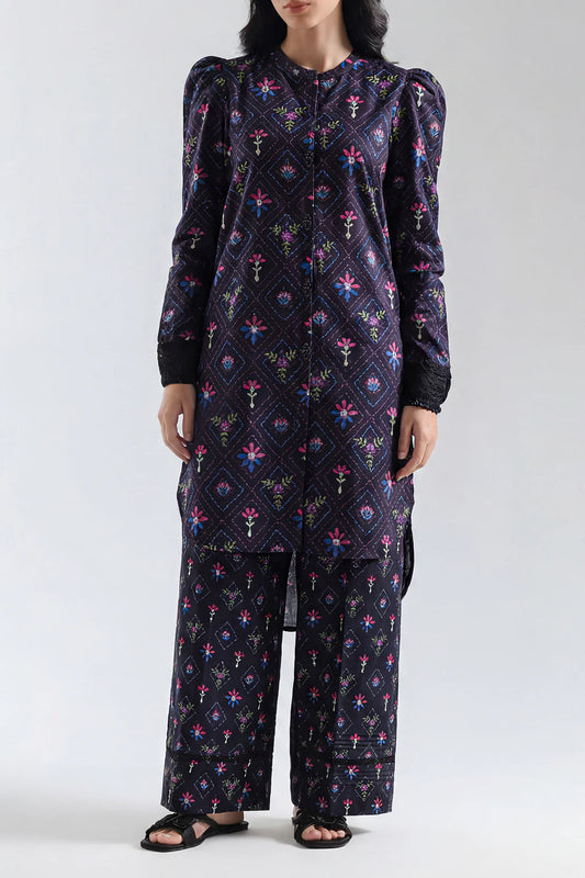 Person wearing a dark blue patterned outfit on a white background