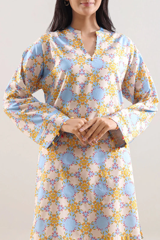 Woman wearing a floral dress with long sleeves on a plain background