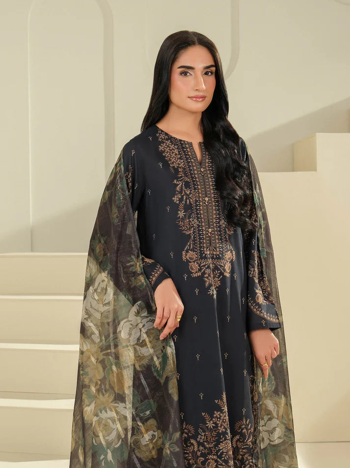 Woman wearing a dark blue embroidered dress with a floral shawl in an indoor setting