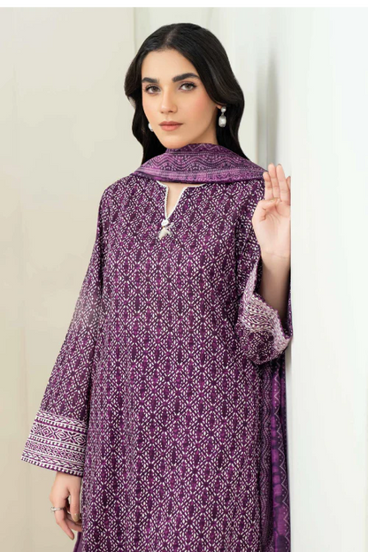 Woman wearing a purple patterned outfit against a white background