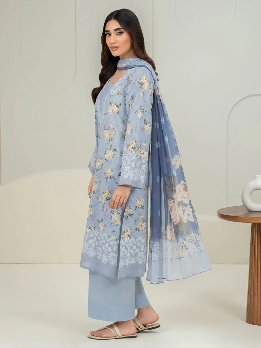 Woman wearing a light blue floral outfit with a white background