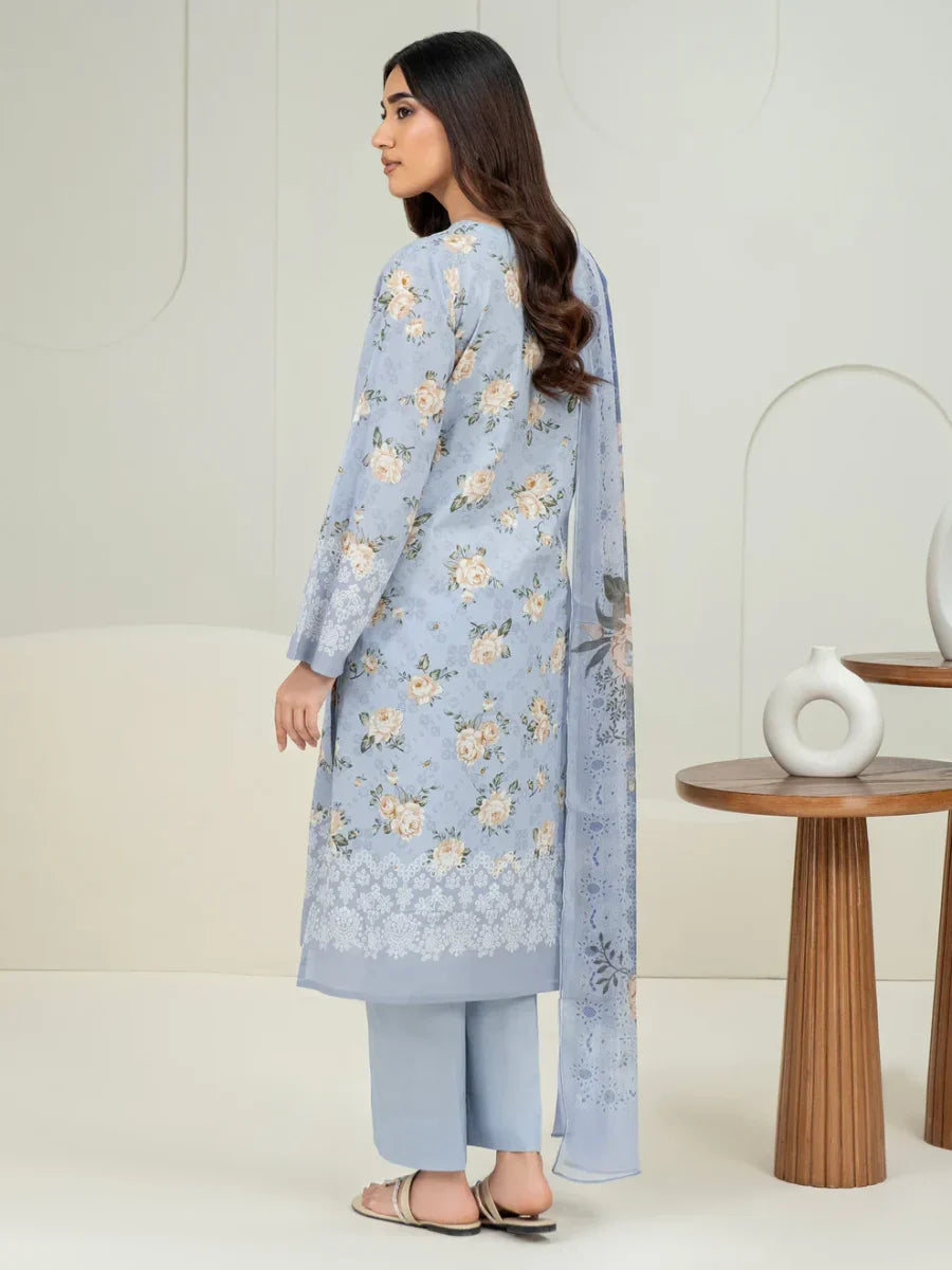 Woman wearing a light blue floral outfit with a white background