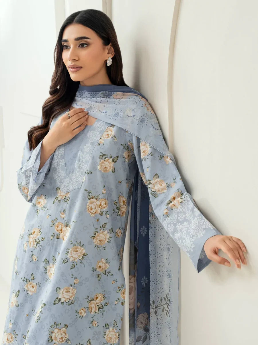 Woman wearing a light blue floral dress against a white background