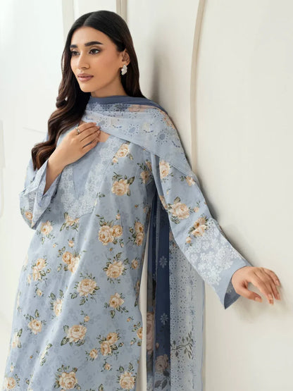 Woman wearing a light blue floral dress against a white background